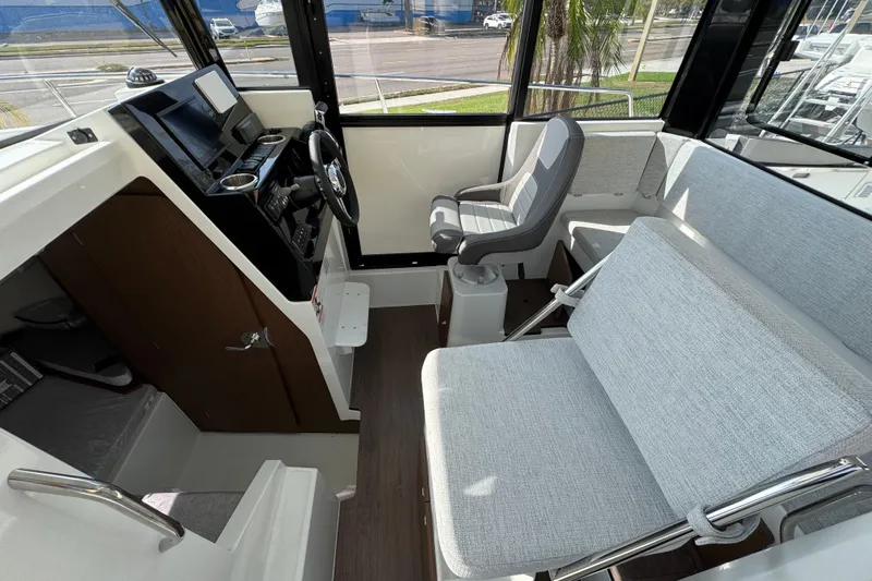  Yacht Photos Pics 2026 Jeanneau NC Sport 795 Series 2 interior with modern seating and steering console.