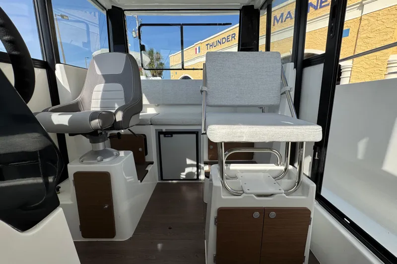  Yacht Photos Pics Interior of 2026 Jeanneau NC Sport 795 Series 2 boat, featuring modern seating and controls.