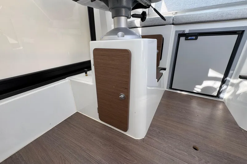  Yacht Photos Pics Interior of 2026 Jeanneau NC Sport 795 Series 2 boat, featuring wood accents and storage.