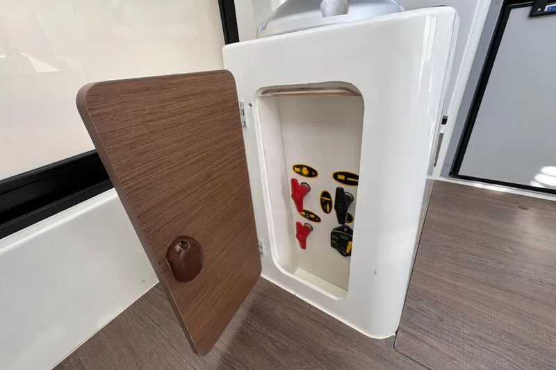  Yacht Photos Pics Open storage compartment in 2026 Jeanneau NC Sport 795 Series 2 boat interior.