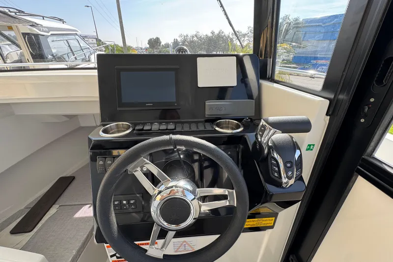  Yacht Photos Pics 2026 Jeanneau NC Sport 795 Series 2 helm with steering wheel and control panel.