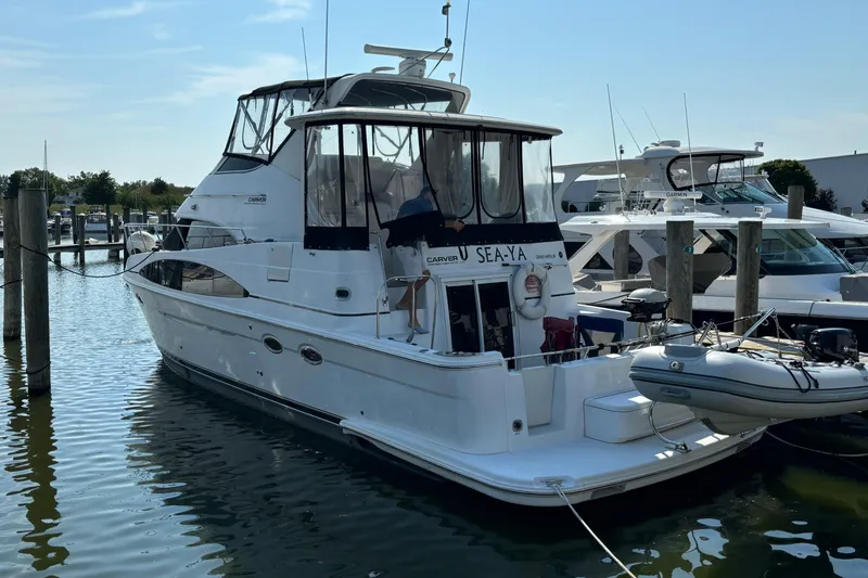  Yacht Photos Pics 2002 Carver 444 Cockpit Motor Yacht docked at marina, rear view.