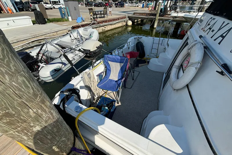  Yacht Photos Pics 2002 Carver 444 Cockpit Motor Yacht docked with inflatable boat and deck chairs.