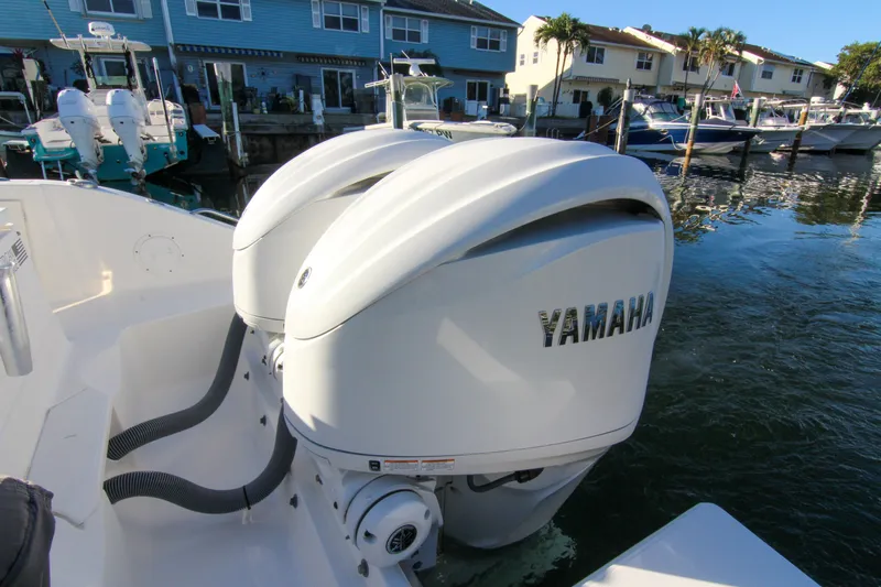 Endeavor Yacht Photos Pics 2023 Pursuit DC 295 Dual Console with Yamaha outboard engines docked by waterfront homes.