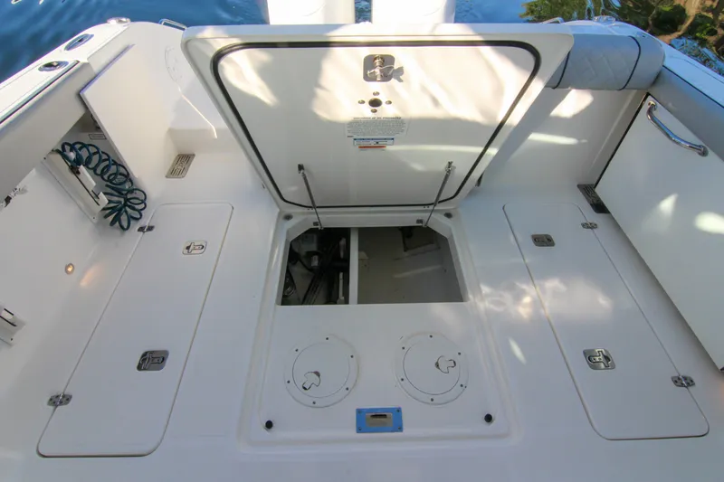 Endeavor Yacht Photos Pics 2023 Pursuit DC 295 Dual Console boat deck with open storage compartments.