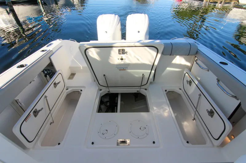 Endeavor Yacht Photos Pics 2023 Pursuit DC 295 Dual Console boat interior with open storage compartments.