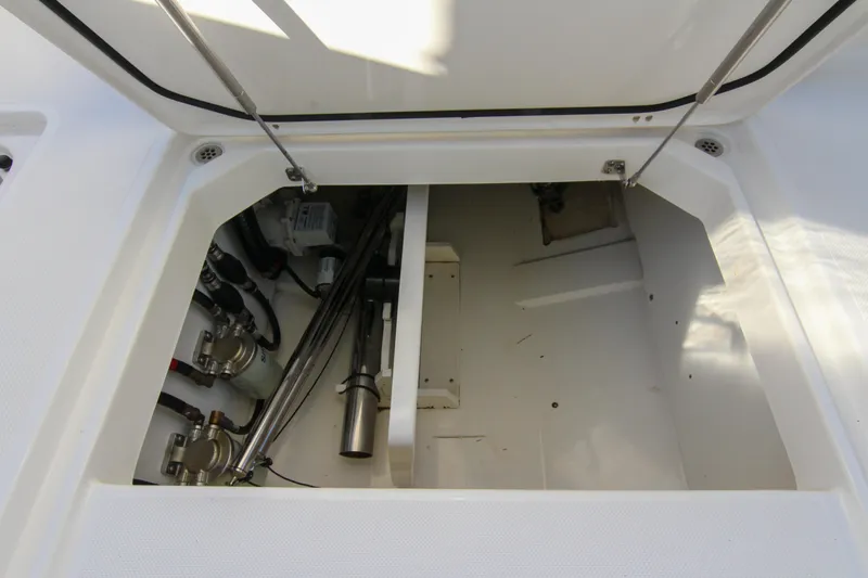Endeavor Yacht Photos Pics 2023 Pursuit DC 295 Dual Console storage compartment with mechanical components visible.