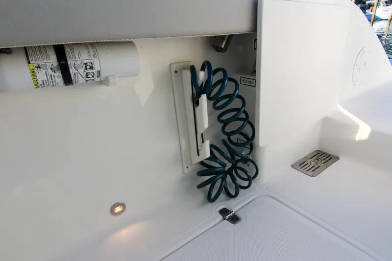 Endeavor Yacht Photos Pics 2023 Pursuit DC 295 Dual Console boat with coiled hose and fire extinguisher.