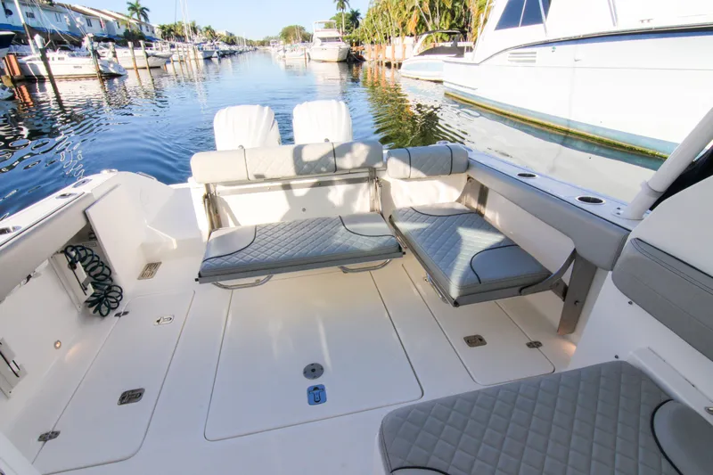 Endeavor Yacht Photos Pics 2023 Pursuit DC 295 Dual Console boat interior with seating and water view.