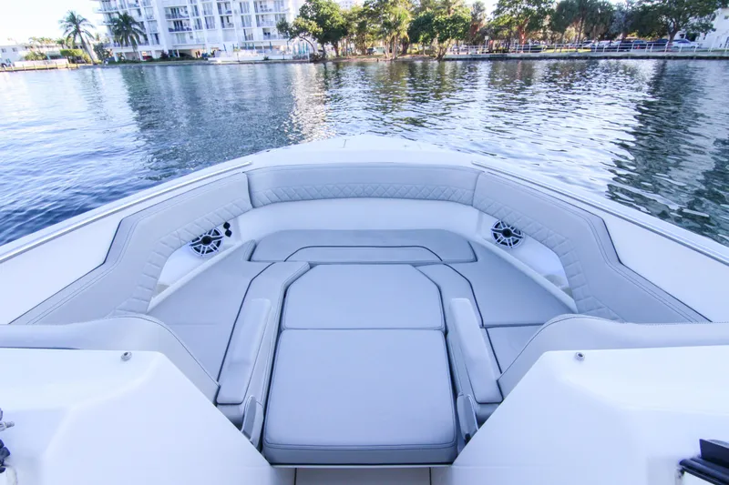 Endeavor Yacht Photos Pics 2023 Pursuit DC 295 Dual Console boat interior with luxurious seating on calm water.