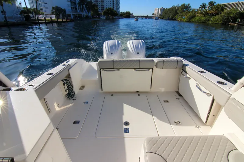 Endeavor Yacht Photos Pics 2023 Pursuit DC 295 Dual Console boat on a scenic waterway.