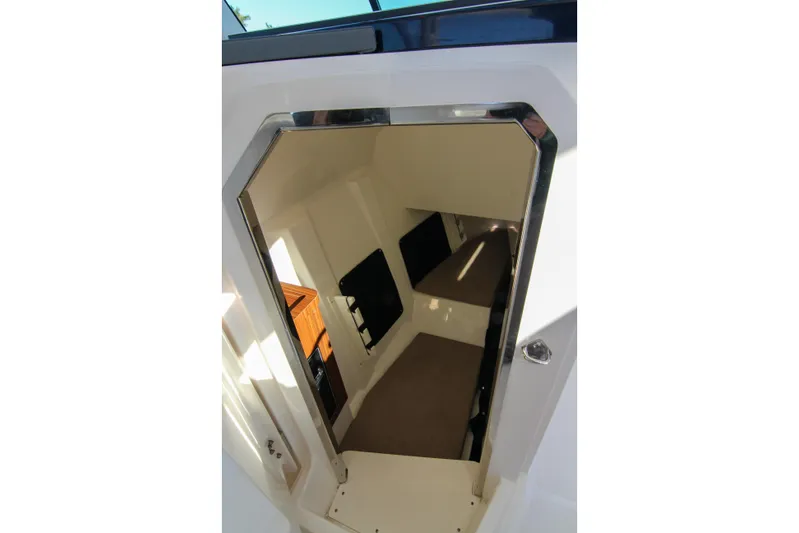 Endeavor Yacht Photos Pics 2023 Pursuit DC 295 Dual Console cabin interior with seating and storage.