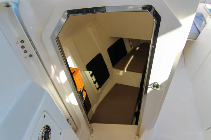 Endeavor Yacht Photos Pics 2023 Pursuit DC 295 Dual Console cabin interior with open door view.