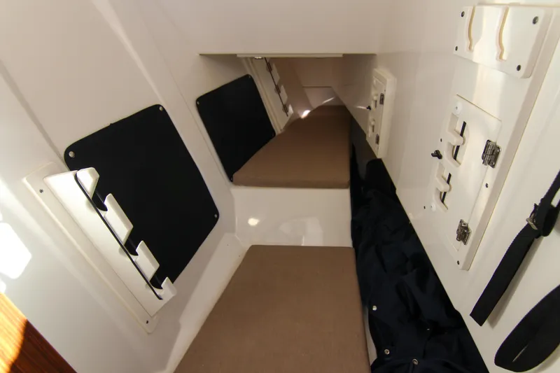 Endeavor Yacht Photos Pics 2023 Pursuit DC 295 Dual Console cabin interior with storage compartments and seating.