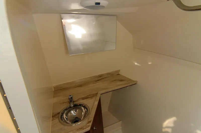 Endeavor Yacht Photos Pics 2023 Pursuit DC 295 Dual Console interior with sink and mirror.