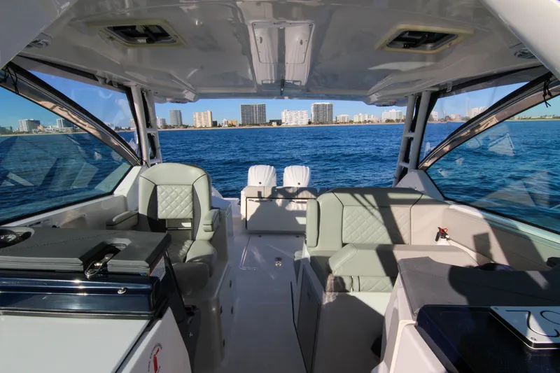 Endeavor Yacht Photos Pics 2023 Pursuit DC 295 Dual Console boat interior with ocean and city skyline view.