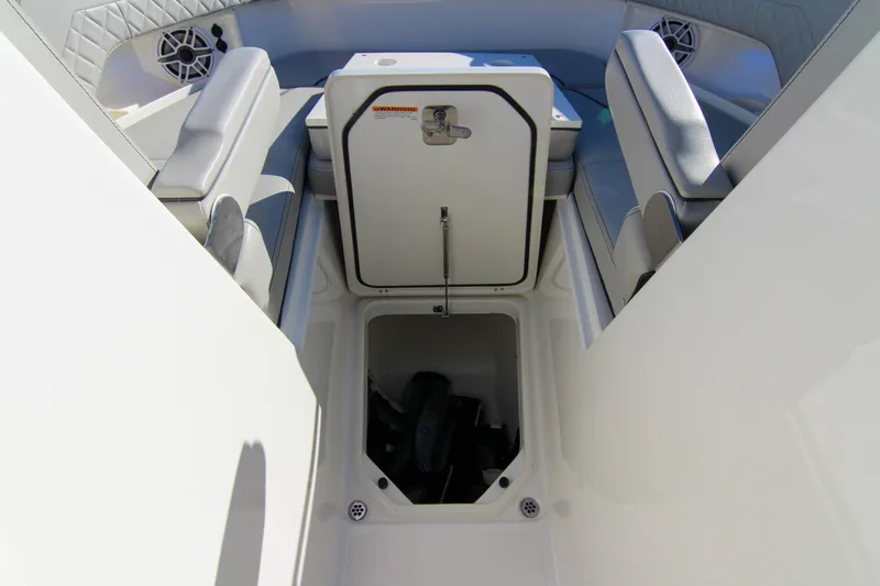 Endeavor Yacht Photos Pics 2023 Pursuit DC 295 Dual Console boat interior with storage compartment open.