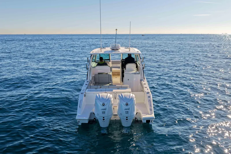 Endeavor Yacht Photos Pics 2023 Pursuit DC 295 Dual Console boat on open water, rear view.