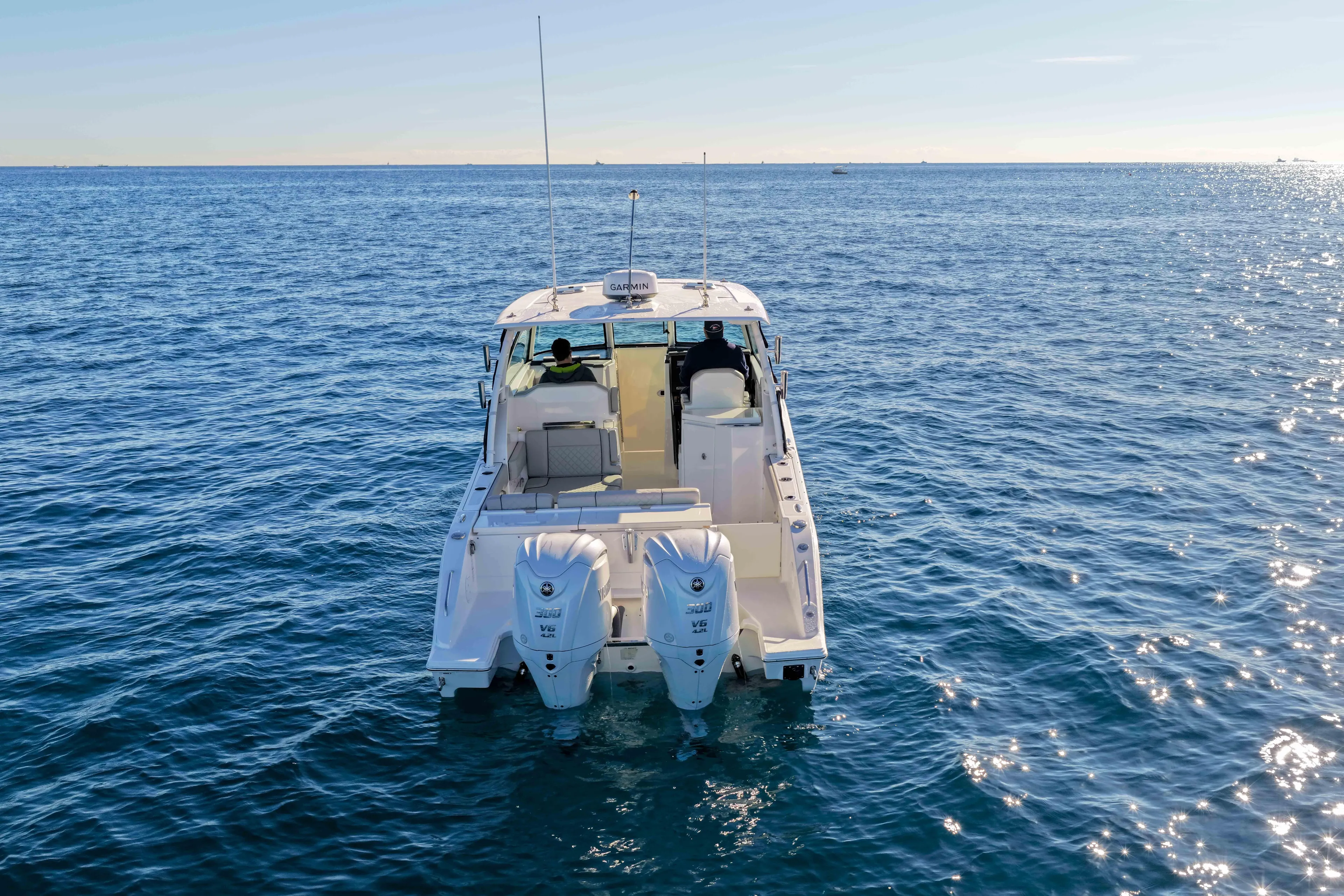 Endeavor Yacht Photos Pics 2023 Pursuit DC 295 Dual Console boat on open water, rear view.