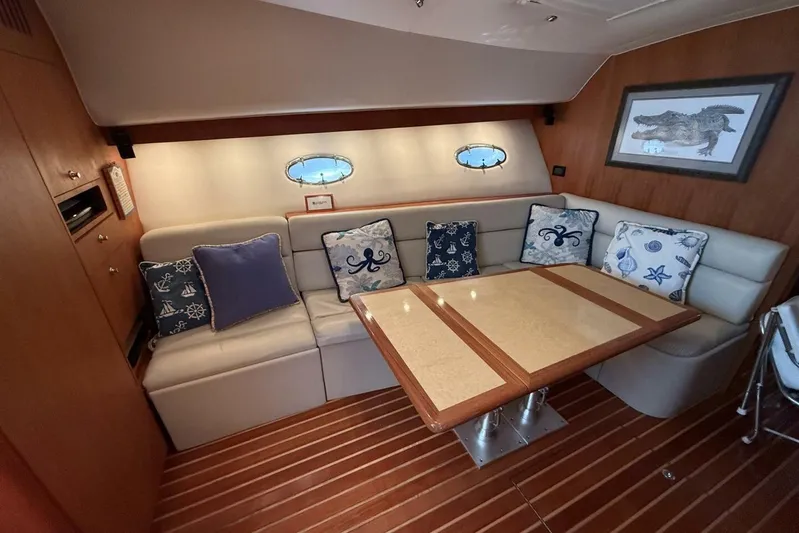 Grande Gator Yacht Photos Pics Interior of 2004 Tiara Yachts 4200 Open with cozy seating and nautical-themed cushions.
