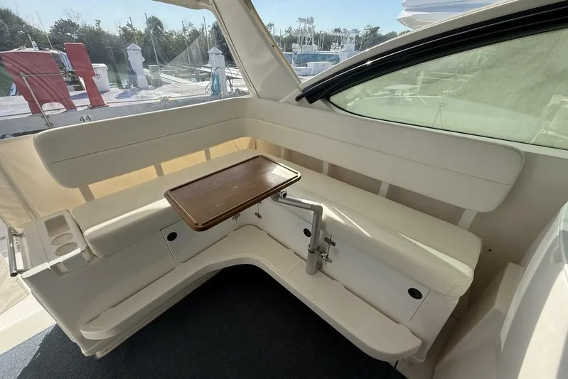 Grande Gator Yacht Photos Pics 2004 Tiara Yachts 4200 Open interior with white seating and wooden table.