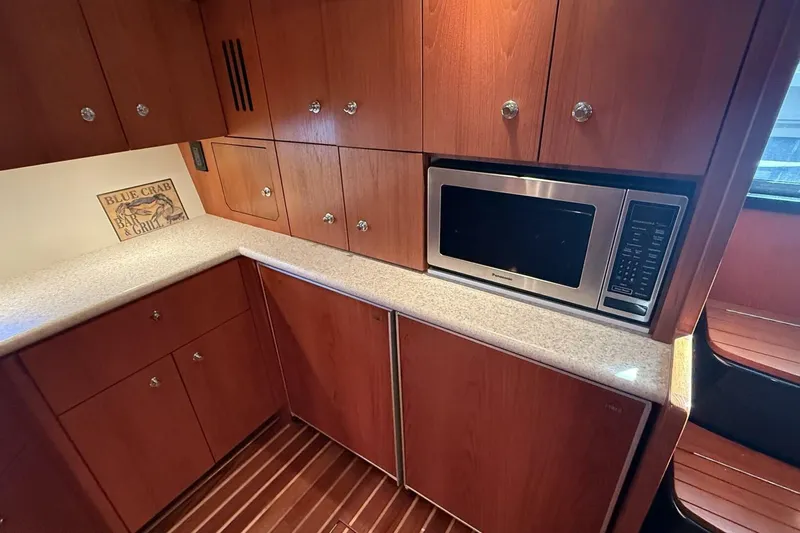 Grande Gator Yacht Photos Pics 2004 Tiara Yachts 4200 Open galley with wood cabinets and built-in microwave.