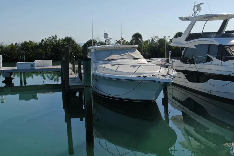 Grande Gator Yacht Photos Pics 2004 Tiara Yachts 4200 Open docked in a serene marina setting.