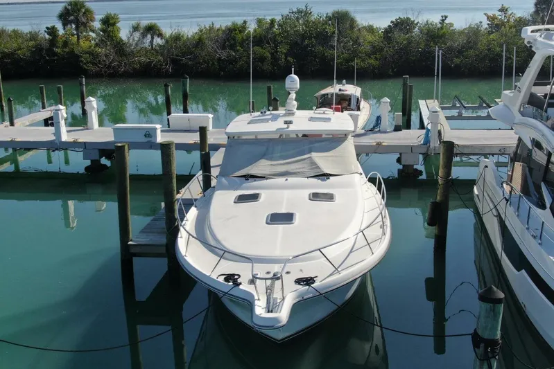 Grande Gator Yacht Photos Pics 2004 Tiara Yachts 4200 Open docked in serene marina setting.