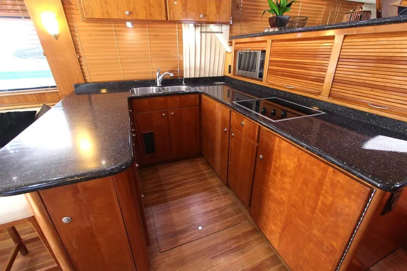 No Name Yacht Photos Pics Luxurious 2006 Navigator 5400 yacht kitchen with sleek wood cabinetry and modern appliances.
