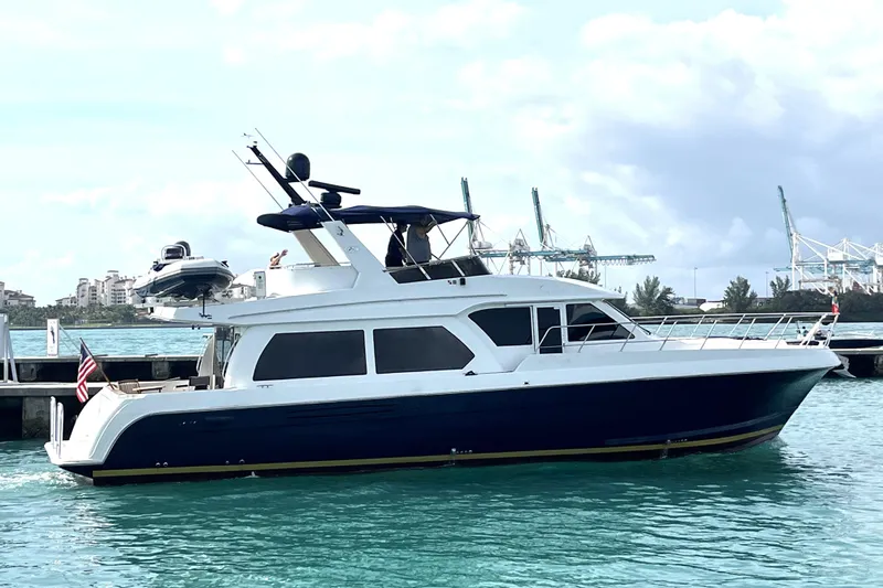 No Name Yacht Photos Pics 2006 Navigator 5400 yacht docked in a marina with clear blue water.