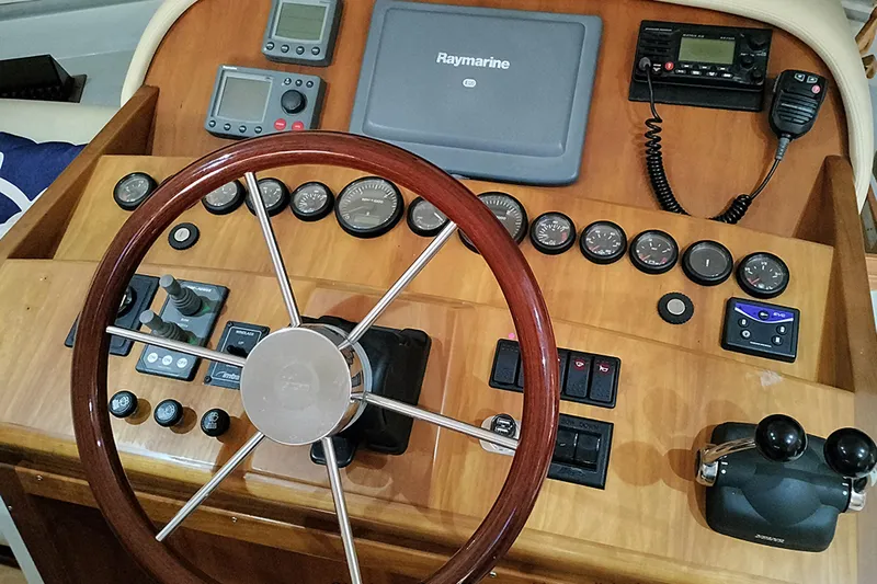 No Name Yacht Photos Pics 2006 Navigator 5400 yacht helm with Raymarine electronics and wooden steering wheel.