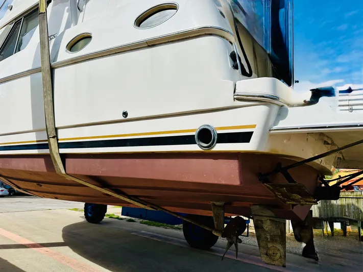 Precious Time Yacht Photos Pics 1998 Silverton 392 Motor Yacht on dry dock, showcasing hull and propeller details.