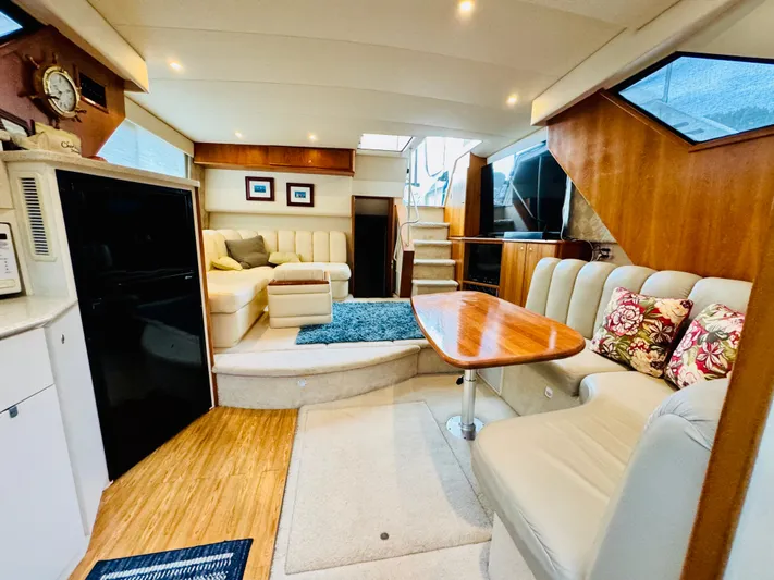 Precious Time Yacht Photos Pics Luxurious interior of a 1998 Silverton 392 Motor Yacht with elegant seating and wooden accents.
