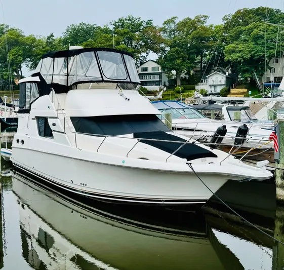 Precious Time Yacht Photos Pics 1998 Silverton 392 Motor Yacht docked in a marina, surrounded by trees and other boats.