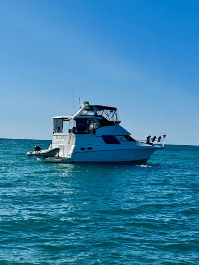 Precious Time Yacht Photos Pics 1998 Silverton 392 Motor Yacht on calm blue ocean under clear sky.
