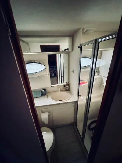 Precious Time Yacht Photos Pics Bathroom interior of 1998 Silverton 392 Motor Yacht with sink, mirror, and shower.