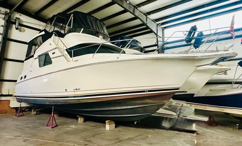 Precious Time Yacht Photos Pics 1998 Silverton 392 Motor Yacht in indoor storage, side view.