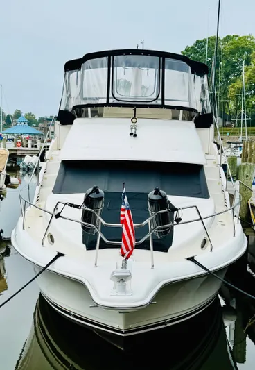 Precious Time Yacht Photos Pics 1998 Silverton 392 Motor Yacht docked with American flag displayed.