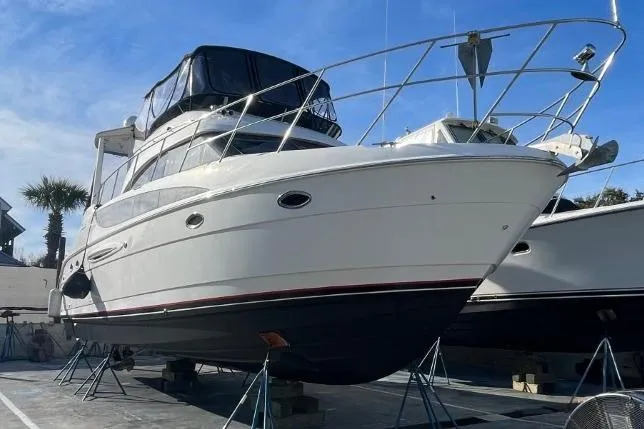 Good Times Yacht Photos Pics 2004 Meridian 459 Motoryacht on stands, white hull, blue sky background.