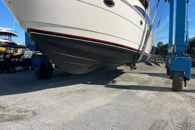 Good Times Yacht Photos Pics 2004 Meridian 459 Motoryacht being lifted by a blue crane at a marina.