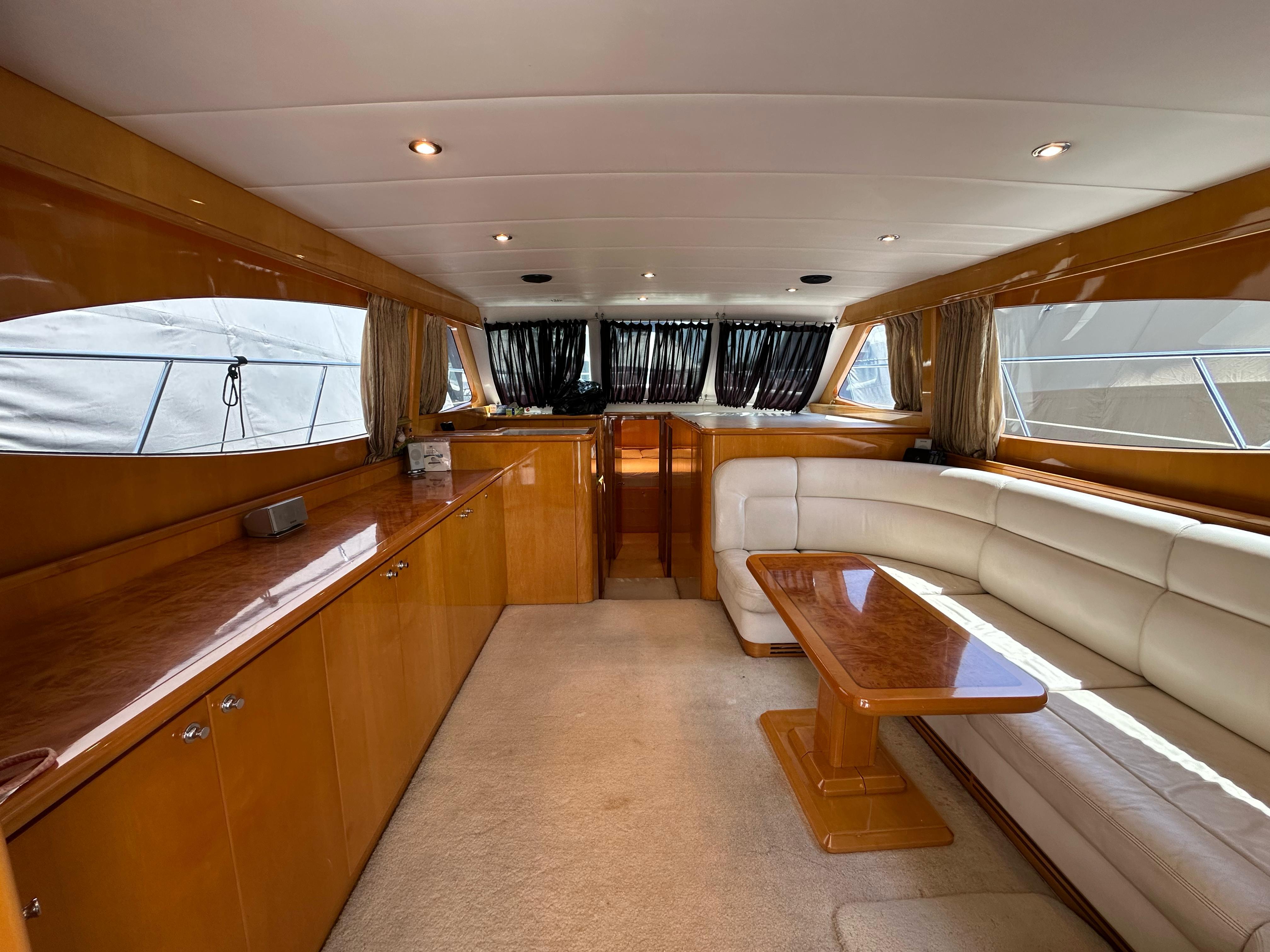 Luxurious interior of 2005 Ruby 45 yacht with elegant wood finishes and plush seating.