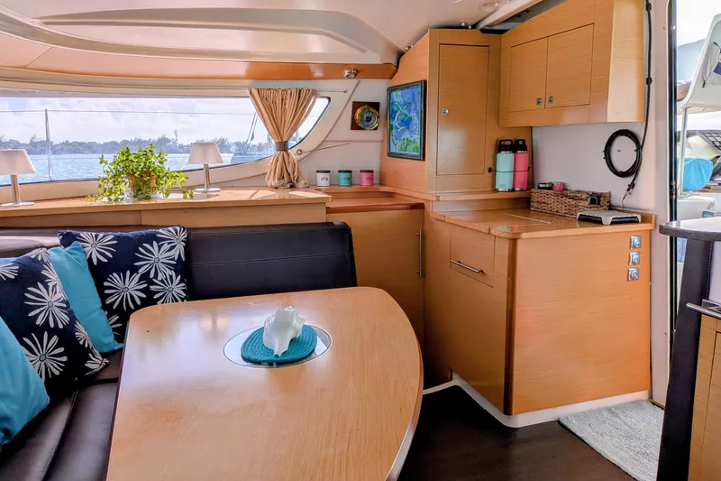 Imany Yacht Photos Pics Interior of 2012 Fountaine Pajot Lipari Owners Version catamaran, featuring cozy dining area and modern decor.