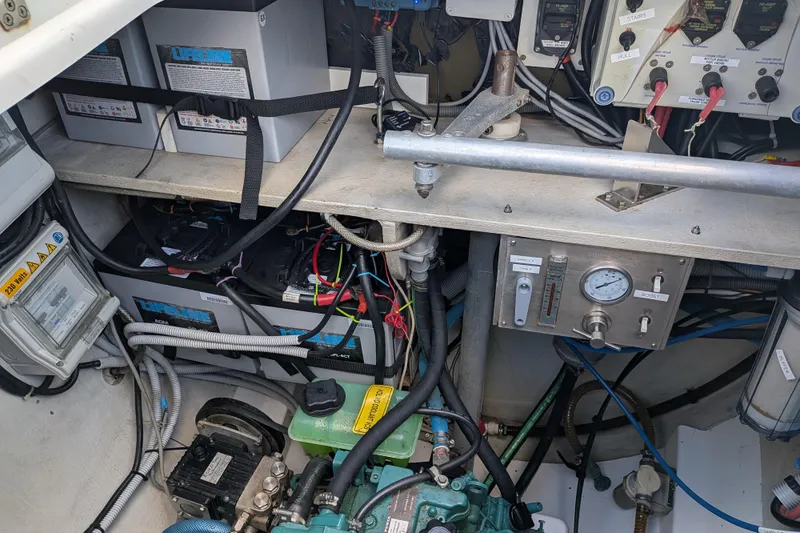 Imany Yacht Photos Pics Engine room of 2012 Fountaine Pajot Lipari catamaran with batteries and control panel.