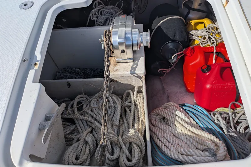 Imany Yacht Photos Pics Storage compartment of 2012 Fountaine Pajot Lipari with ropes, chains, and fuel containers.