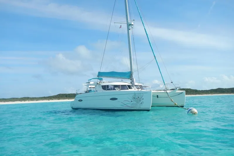 Imany Yacht Photos Pics 2012 Fountaine Pajot Lipari catamaran anchored in clear turquoise waters.