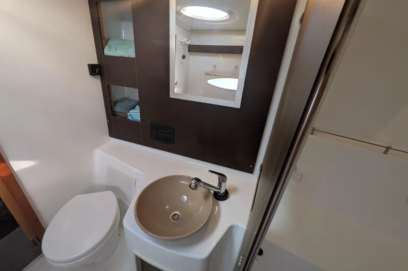 Imany Yacht Photos Pics Bathroom interior of 2012 Fountaine Pajot Lipari catamaran, featuring sink and toilet.