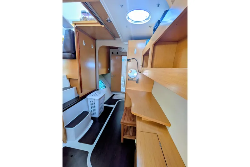 Imany Yacht Photos Pics Interior of 2012 Fountaine Pajot Lipari catamaran, featuring wooden shelves and modern design.
