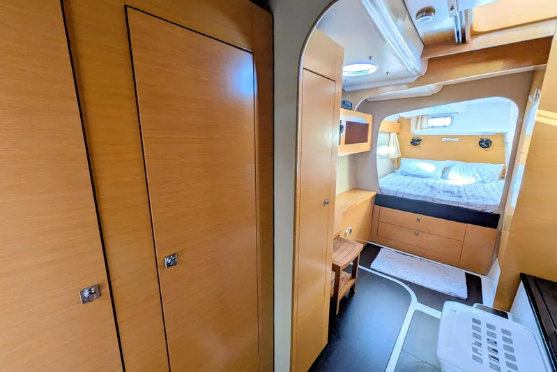 Imany Yacht Photos Pics Interior of 2012 Fountaine Pajot Lipari catamaran, featuring cozy bedroom and wooden cabinetry.