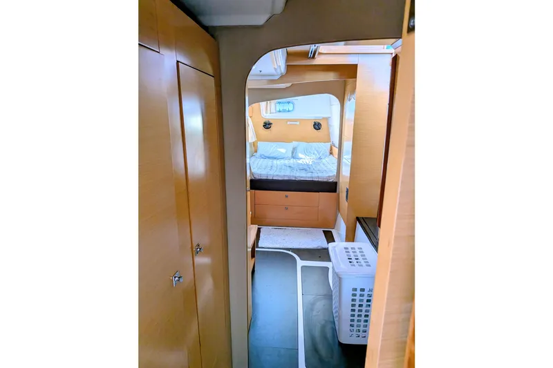 Imany Yacht Photos Pics Interior of 2012 Fountaine Pajot Lipari catamaran, featuring cozy bedroom and wooden cabinetry.