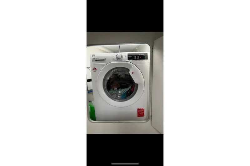 Imany Yacht Photos Pics Washing machine inside 2012 Fountaine Pajot Lipari catamaran, compact laundry setup.